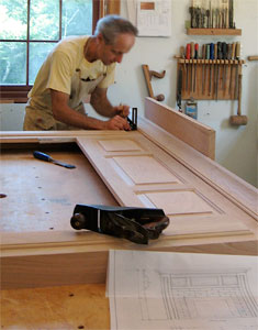 Jim works on his hand-crafted crown molding.